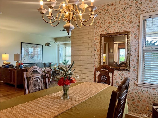 dining room featuring a notable chandelier, hardwood / wood-style flooring, and a wealth of natural light