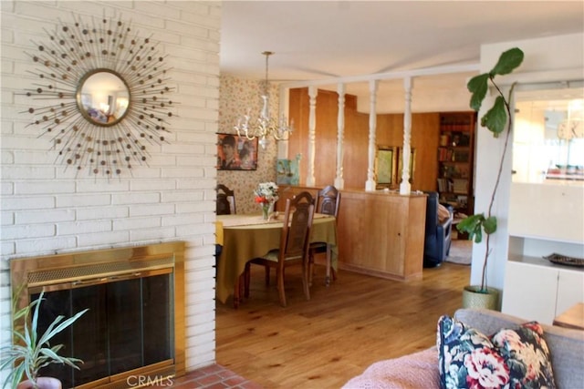 living room with hardwood / wood-style floors and a brick fireplace