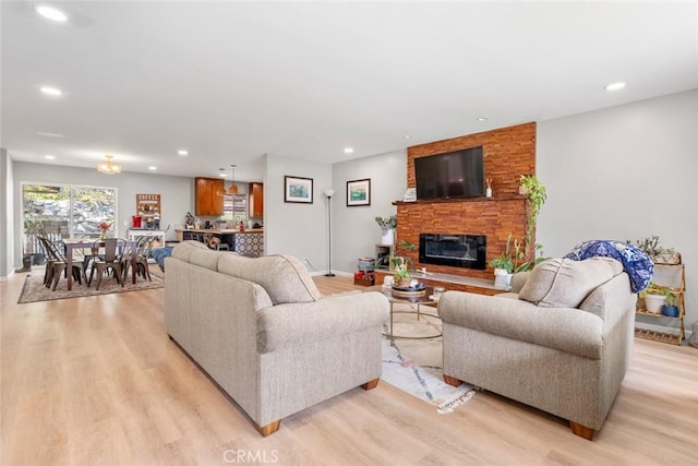 living room featuring a fireplace and light hardwood / wood-style flooring