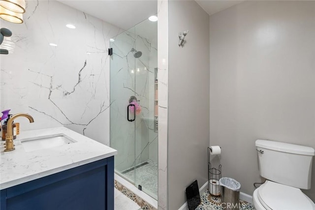 bathroom with vanity, toilet, and a shower with shower door