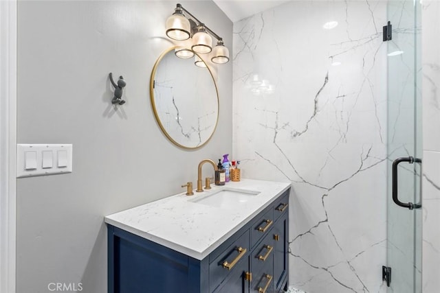 bathroom featuring vanity and a shower with shower door