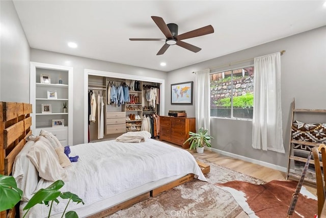 bedroom featuring ceiling fan, wood-type flooring, and a closet