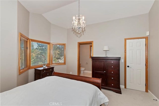 bedroom featuring a notable chandelier, lofted ceiling, light colored carpet, and connected bathroom