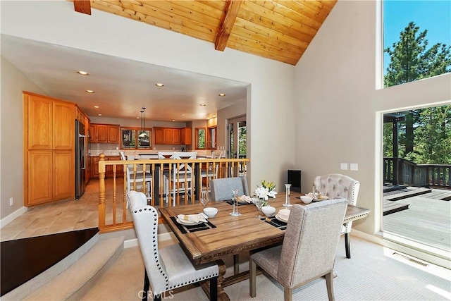 dining room with wood ceiling and lofted ceiling with beams