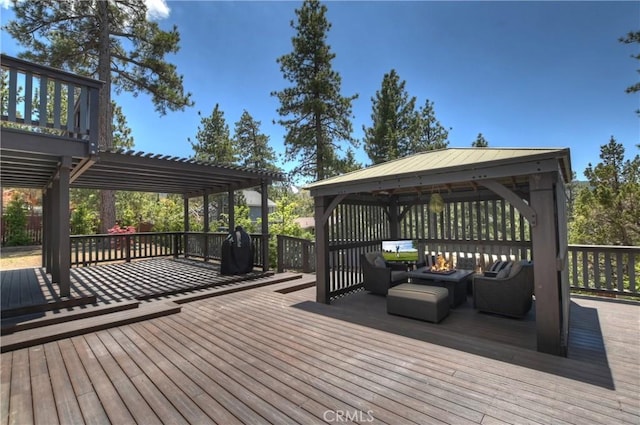 wooden deck featuring a gazebo, an outdoor living space with a fire pit, and a pergola