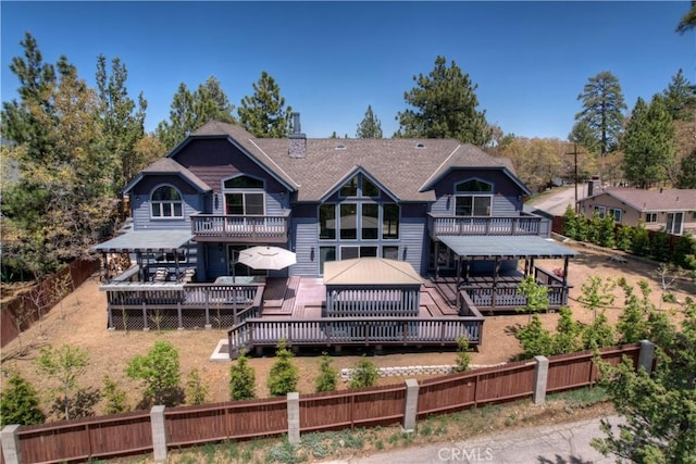 back of house featuring a wooden deck and a gazebo