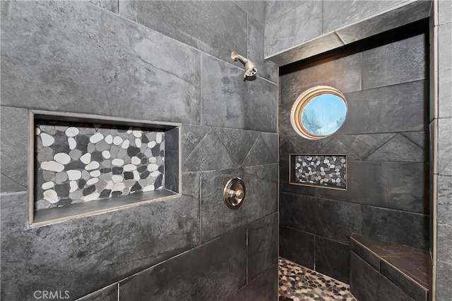 bathroom with a tile shower