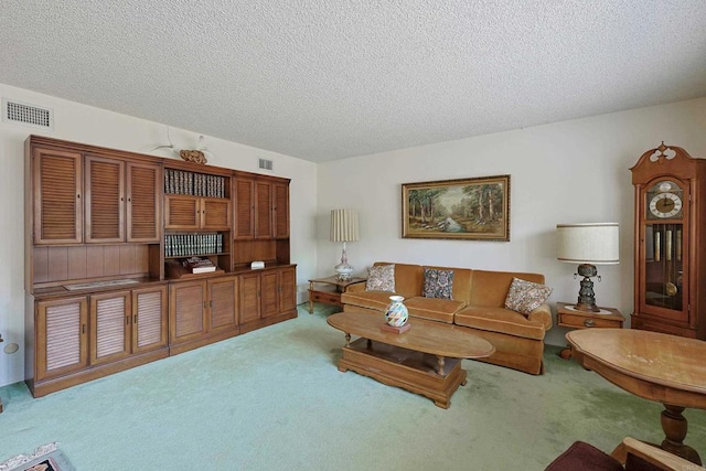 carpeted living room featuring a textured ceiling