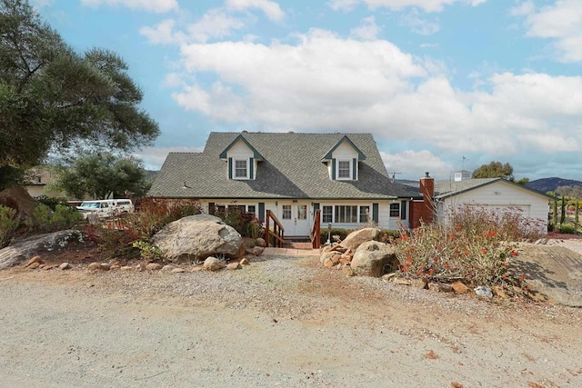 cape cod house featuring a garage