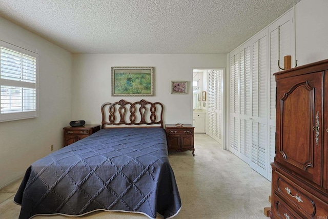 carpeted bedroom featuring a textured ceiling