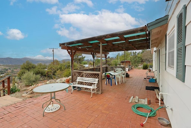 view of patio / terrace featuring a pergola, a mountain view, and an outdoor bar