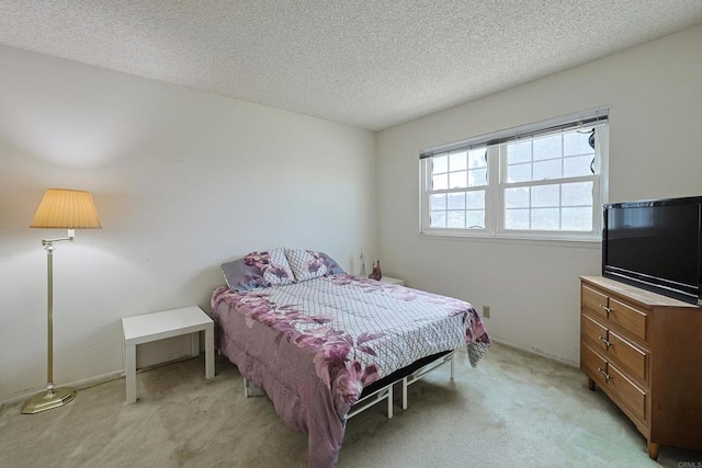 carpeted bedroom featuring a textured ceiling