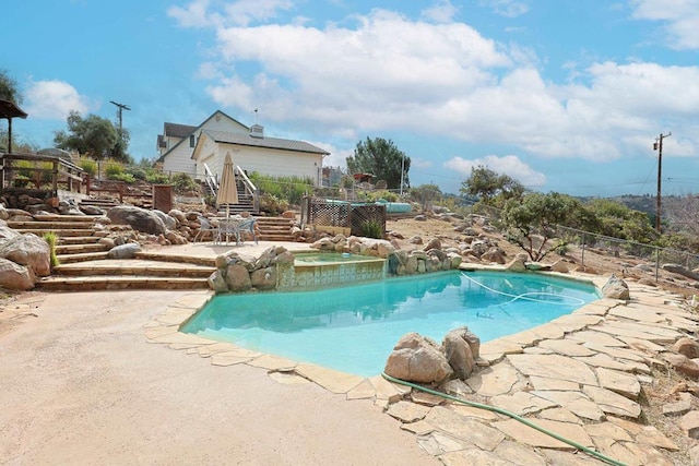 view of swimming pool featuring an in ground hot tub