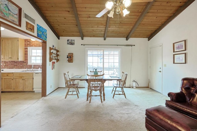 carpeted dining room featuring ceiling fan, lofted ceiling with beams, sink, and wooden ceiling