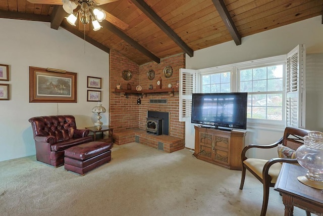 carpeted living room with vaulted ceiling with beams, wooden ceiling, ceiling fan, and a wood stove