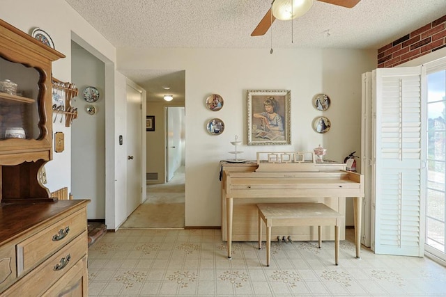 sitting room featuring ceiling fan and a textured ceiling