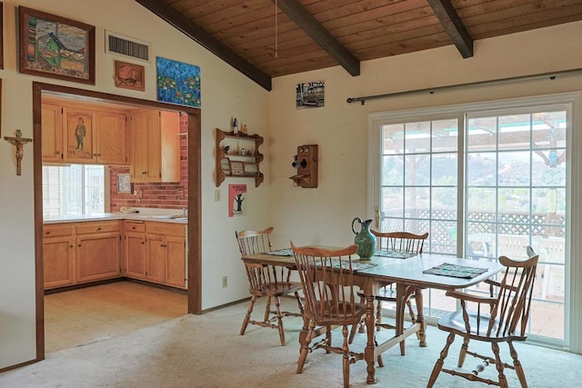 dining area with vaulted ceiling with beams, wood ceiling, and light colored carpet