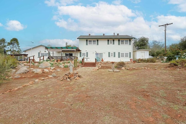 rear view of property featuring a deck