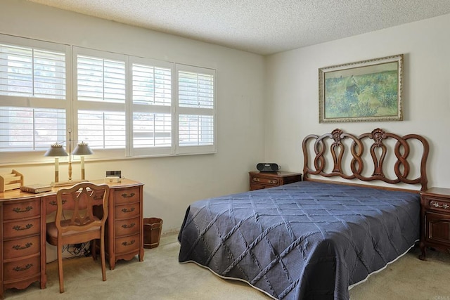 bedroom with light carpet and a textured ceiling