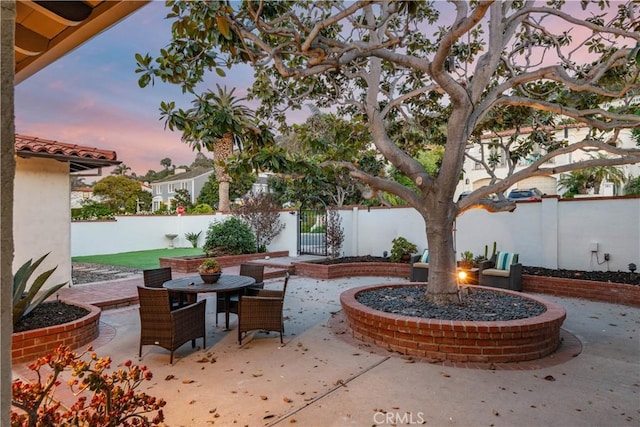 view of patio terrace at dusk