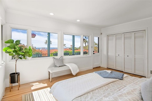 bedroom featuring hardwood / wood-style flooring and crown molding