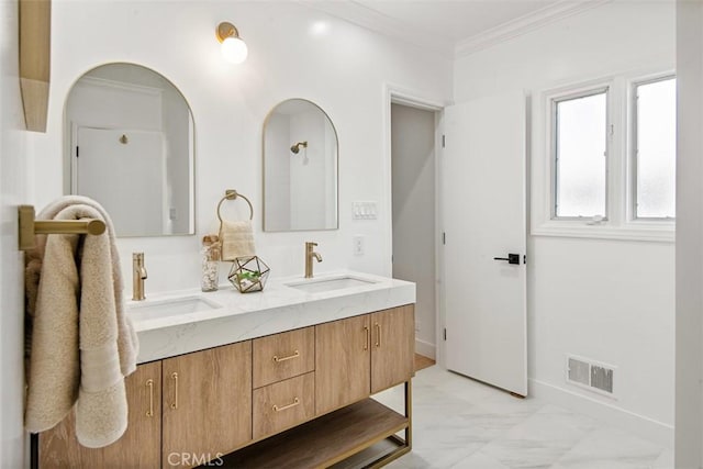 bathroom with crown molding and vanity