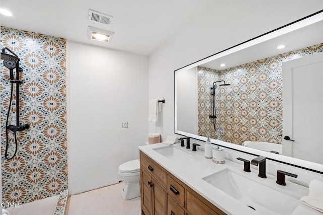 bathroom with visible vents, a sink, a tile shower, and double vanity