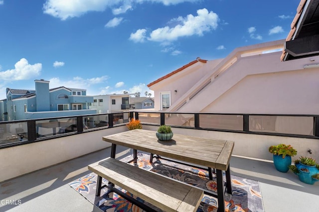 view of patio with outdoor dining space, a residential view, and a balcony