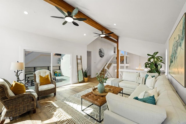 living room featuring lofted ceiling with beams, ceiling fan, light wood-style flooring, recessed lighting, and stairway