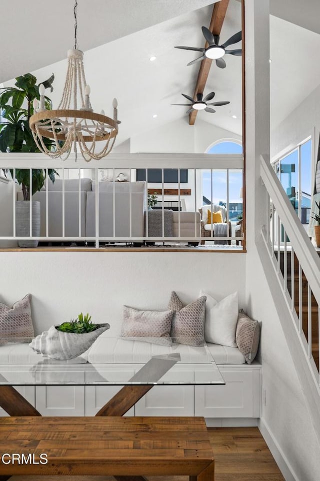 living room featuring vaulted ceiling with beams, recessed lighting, wood finished floors, baseboards, and an inviting chandelier