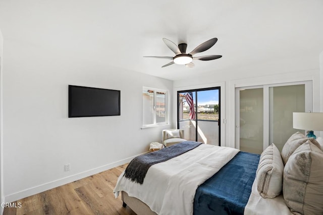 bedroom with light wood finished floors, a ceiling fan, and baseboards