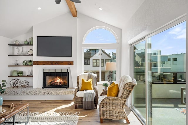 interior space featuring vaulted ceiling with beams, a lit fireplace, light wood finished floors, and recessed lighting