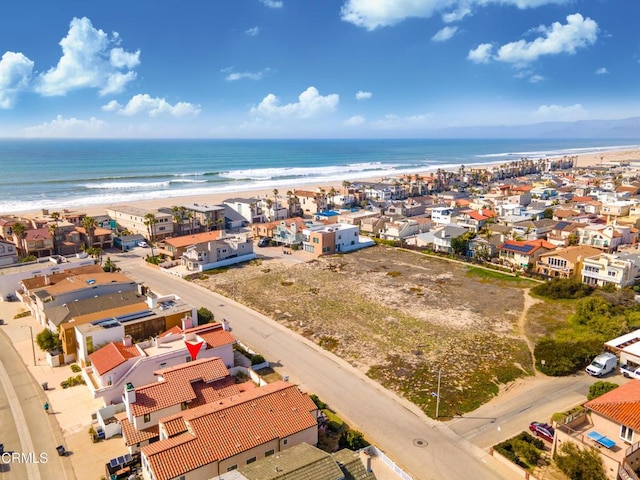 birds eye view of property with a residential view, a water view, and a beach view