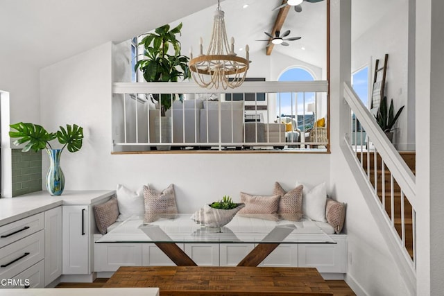 dining space featuring breakfast area, lofted ceiling with beams, and an inviting chandelier