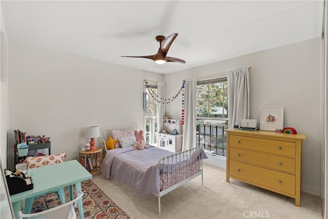 bedroom featuring access to outside, light colored carpet, and ceiling fan