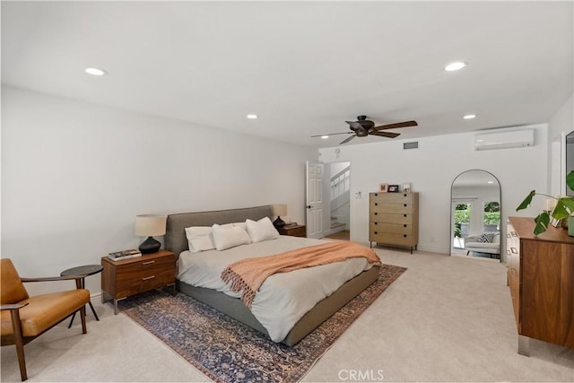 bedroom with ceiling fan, carpet flooring, and a wall mounted AC