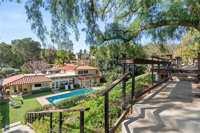 exterior space featuring a patio, a pergola, and a lawn