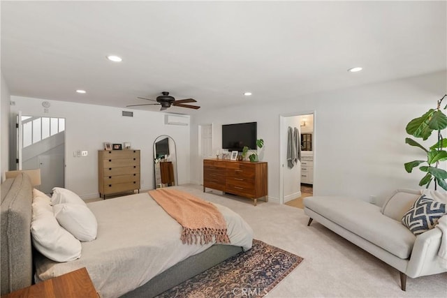 carpeted bedroom with ceiling fan and ensuite bath