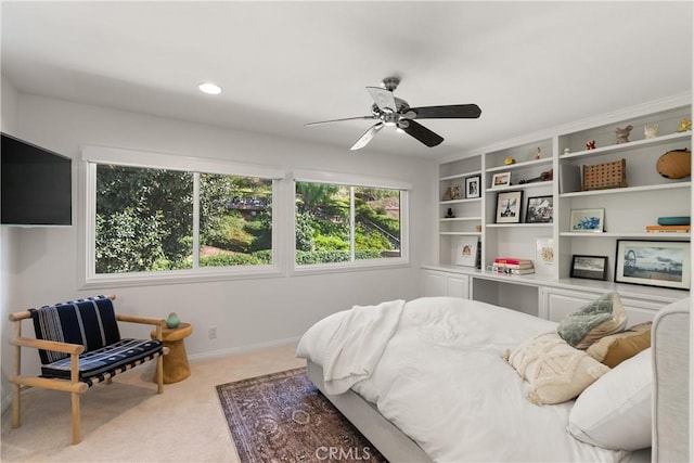 bedroom with ceiling fan, carpet floors, and multiple windows