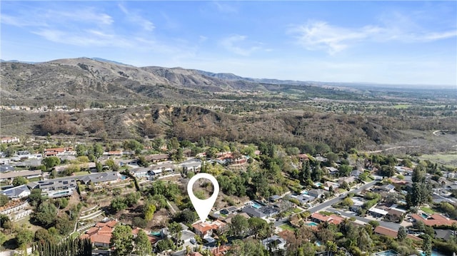 birds eye view of property with a mountain view