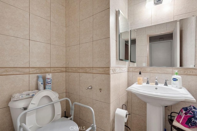 bathroom with tile walls, backsplash, and toilet