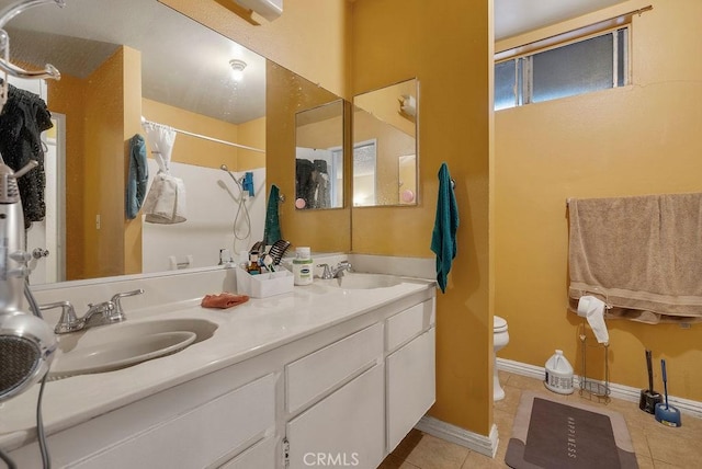 bathroom featuring walk in shower, tile patterned floors, vanity, and toilet