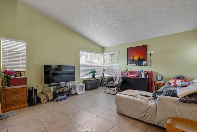 living room with light tile patterned flooring, vaulted ceiling, and a textured ceiling