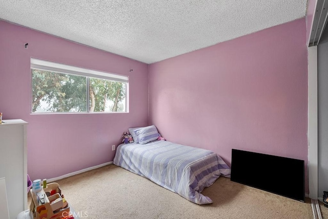 carpeted bedroom featuring a textured ceiling