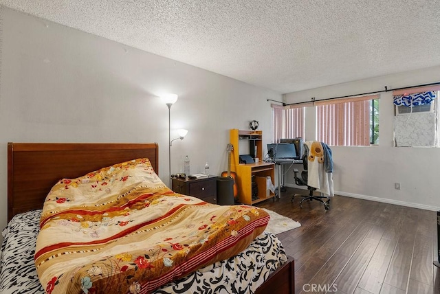 bedroom featuring dark hardwood / wood-style floors and a textured ceiling