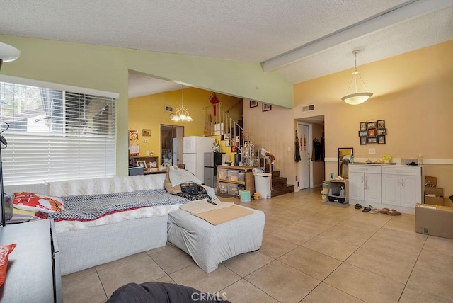 tiled living room with lofted ceiling with beams, a notable chandelier, and a textured ceiling