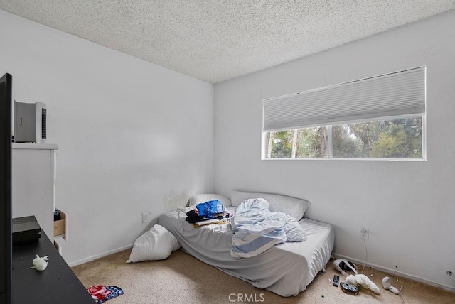 bedroom with carpet flooring and a textured ceiling