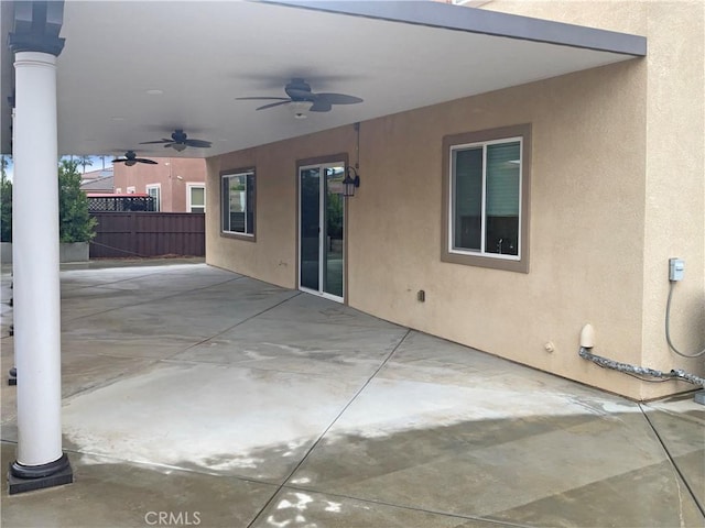 view of patio with fence and a ceiling fan