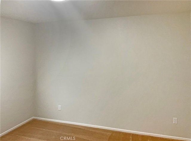 spare room with baseboards