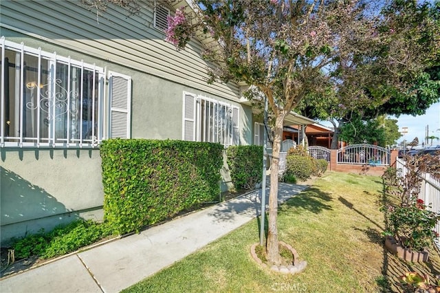 view of side of property with a lawn